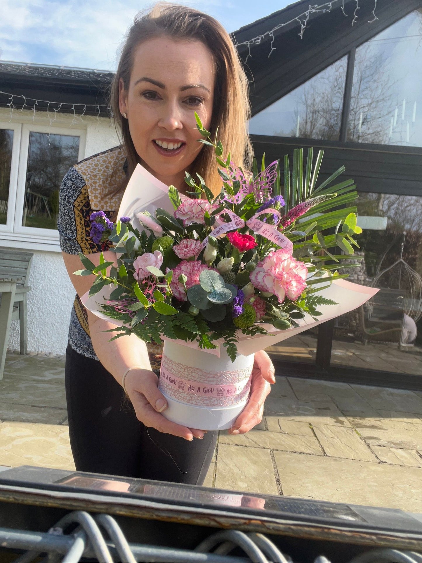 Woman holding a bouquet of flowers outdoors
